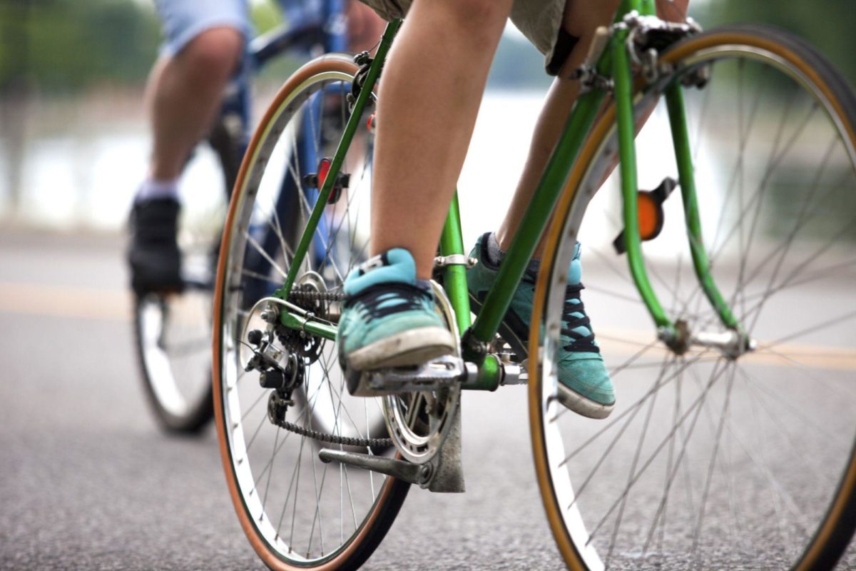 Two people riding their respective bikes.